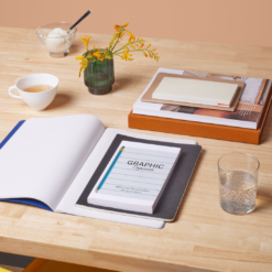 A desk with an open notebook and a close book titled 'graphic organizer'